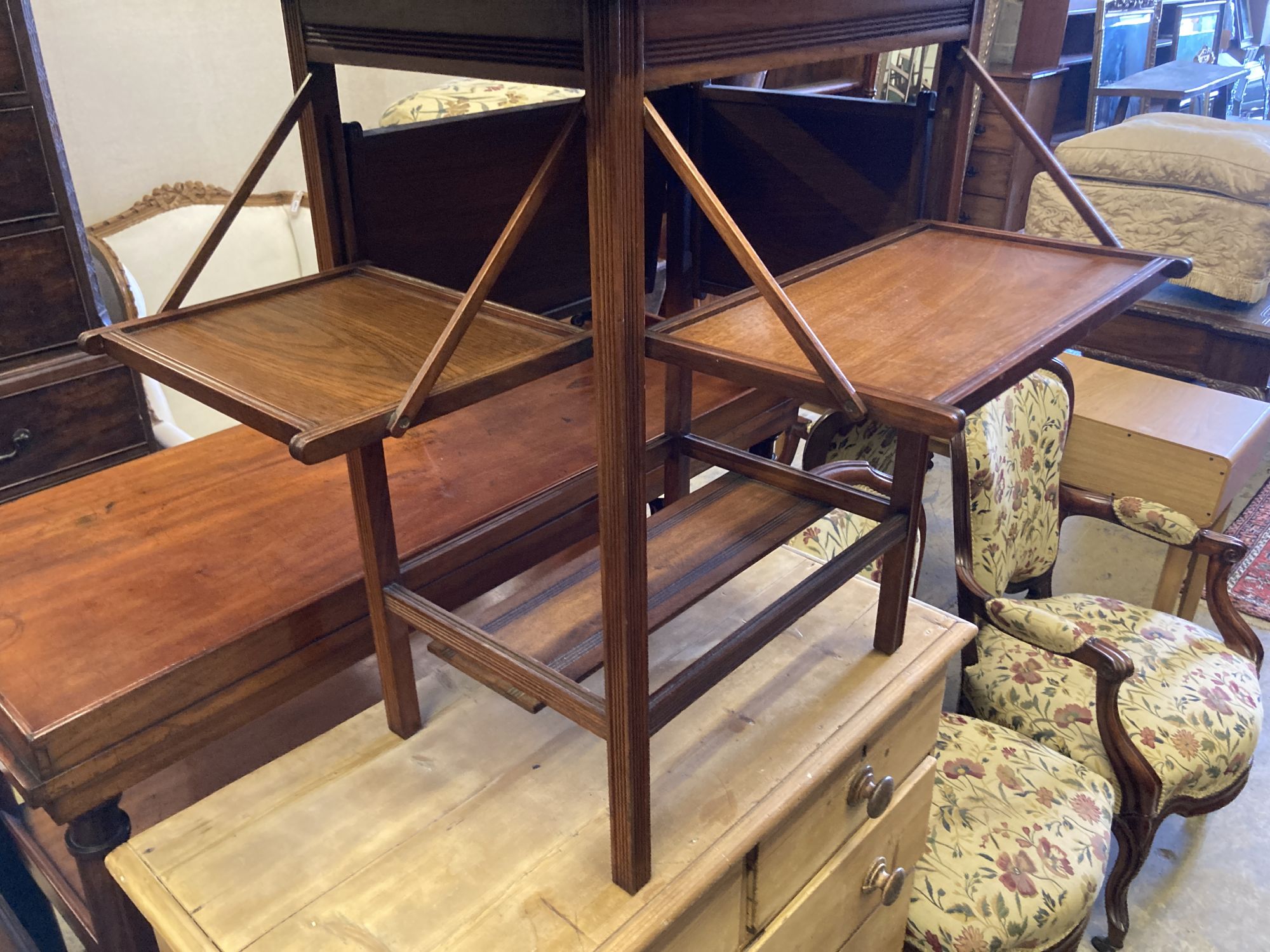 A late Victorian aesthetic movement walnut folding card table, with hinged undertiers, width 71cm, depth 38cm, height 75cm